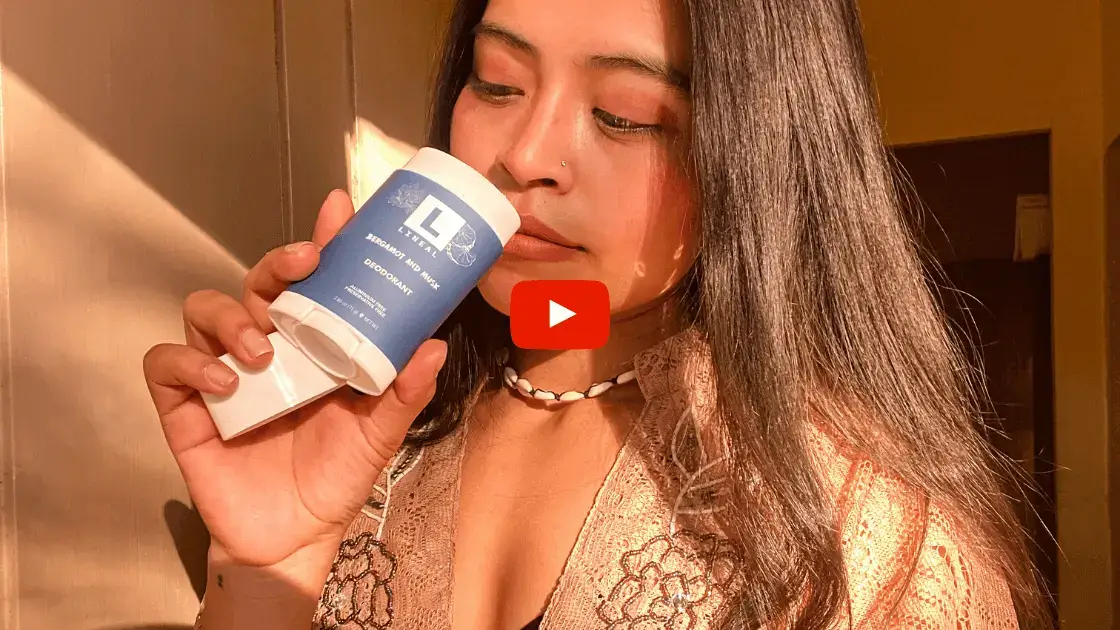 A lady holding a lineal deodorant stick